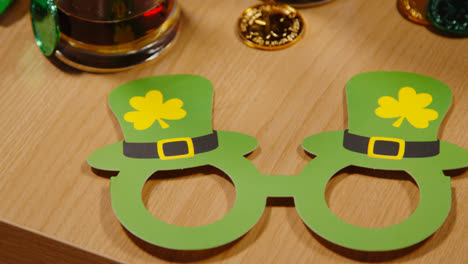 Close-Up-Of-Irish-Novelties-And-Props-Including-Gold-Coins-And-Glasses-Celebrating-At-St-Patrick's-Day-Party